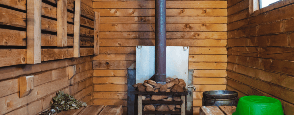 The structure features a cozy wooden sauna equipped with a traditional wood stove.
