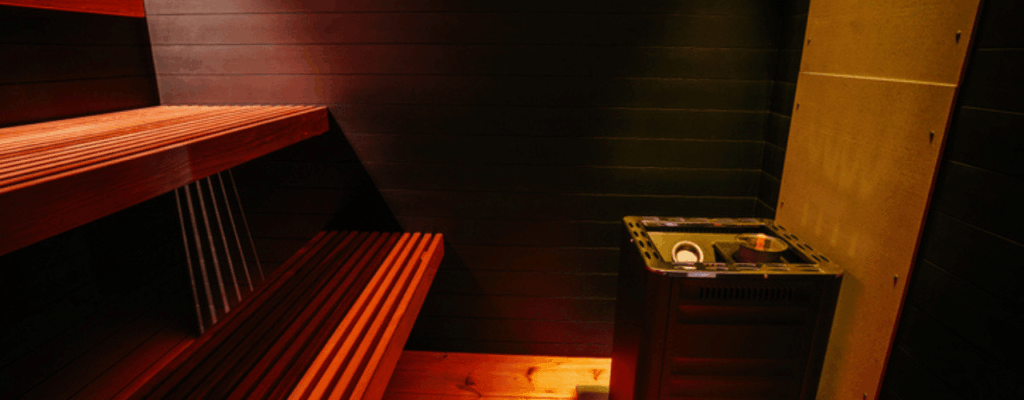 A wooden sauna room equipped with an electric sauna.