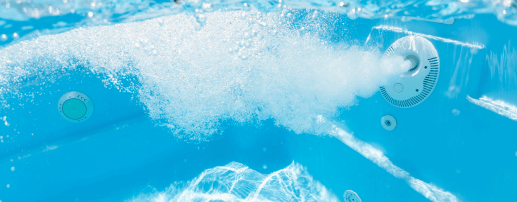 Close-up of a hot tub with water forcefully splashing from a jet, emphasizing the lively movement in the pool.