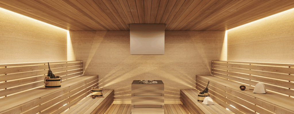 A spacious sauna room featuring wooden walls and benches, designed for relaxation and wellness.
