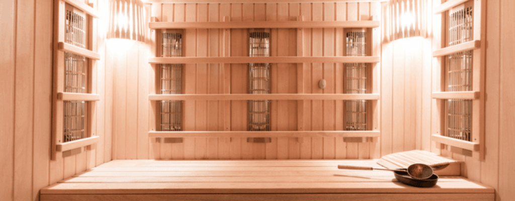 A sauna room featuring wooden walls and shelves, creating a warm and inviting atmosphere for relaxation.